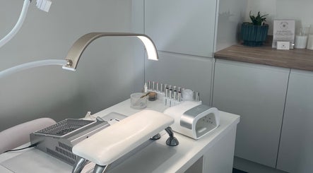 Elegant nail station at Nailsbyalicha in Portsmouth, England, GB, showcasing manicure tools and polish.