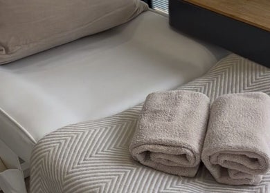 Tranquil spa bed setup with plush towels at Nailsbyalicha, Portsmouth, England, GB.