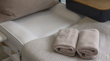 Tranquil spa bed setup with plush towels at Nailsbyalicha, Portsmouth, England, GB.