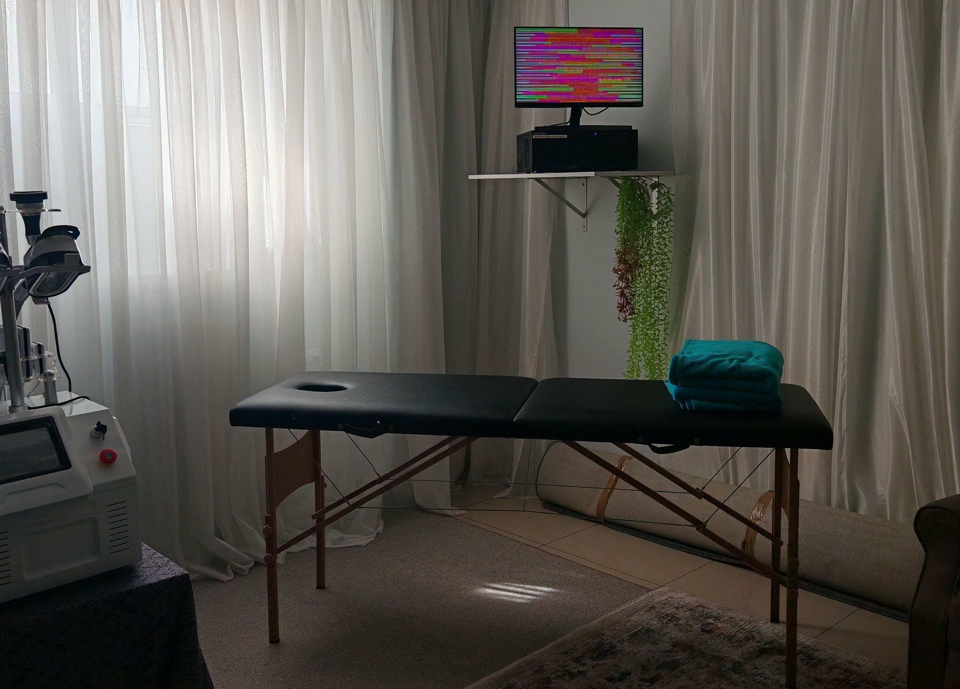 Cozy treatment room at Sozo Wellness, Mossel Bay, Western Cape, ZA with massage bed and equipment.