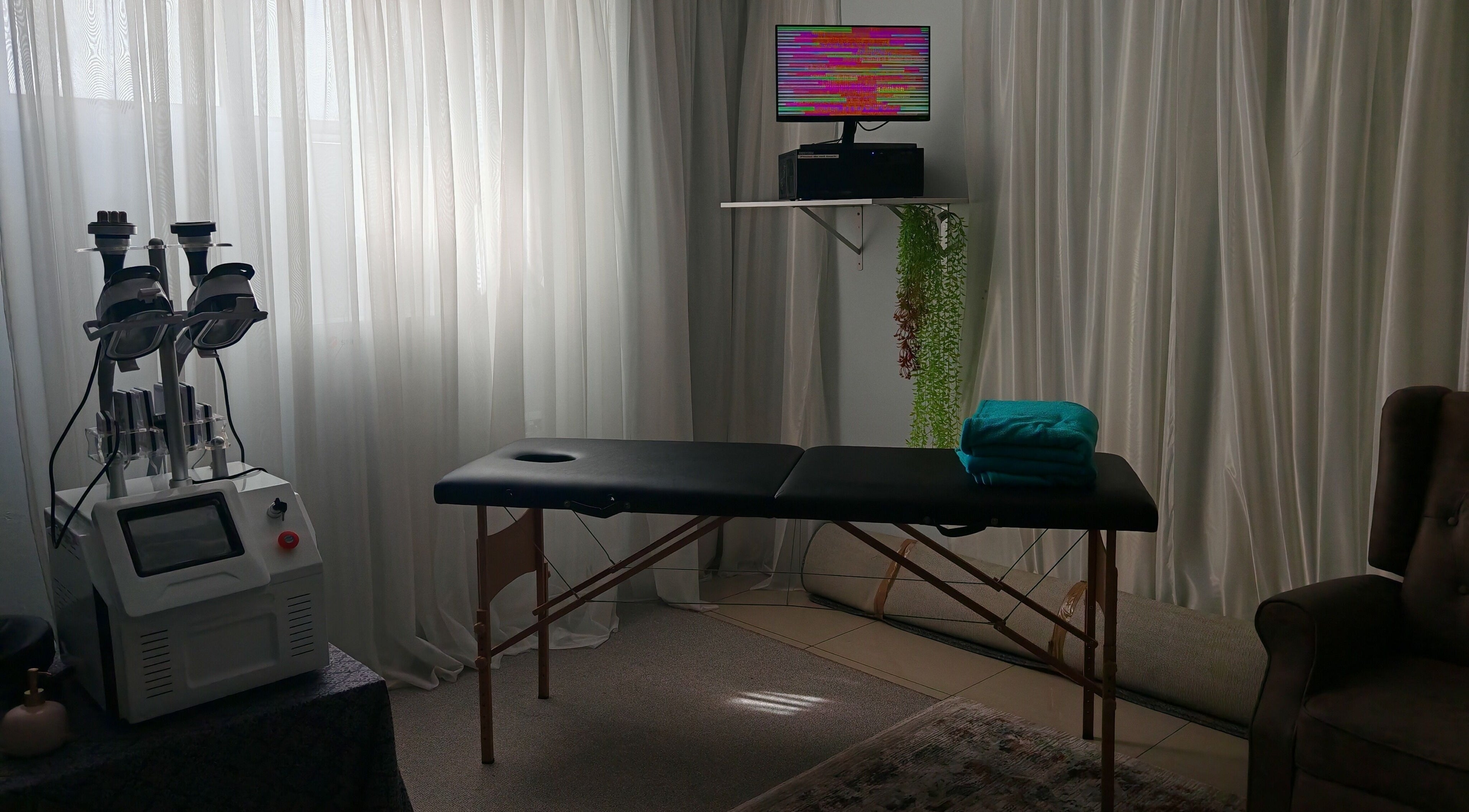 Cozy treatment room at Sozo Wellness, Mossel Bay, Western Cape, ZA with massage bed and equipment.