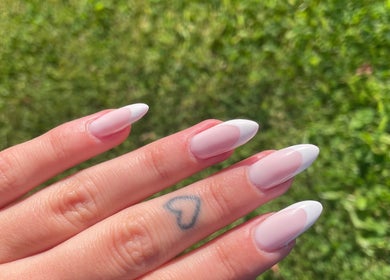Beautiful French manicure at LSNAILBAR, Dumfries, Scotland, GB with delicate heart tattoo.