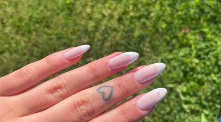 Beautiful French manicure at LSNAILBAR, Dumfries, Scotland, GB with delicate heart tattoo.