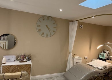 Modern treatment room at CD Studio, featuring a massage table and beauty equipment in London, England, GB.