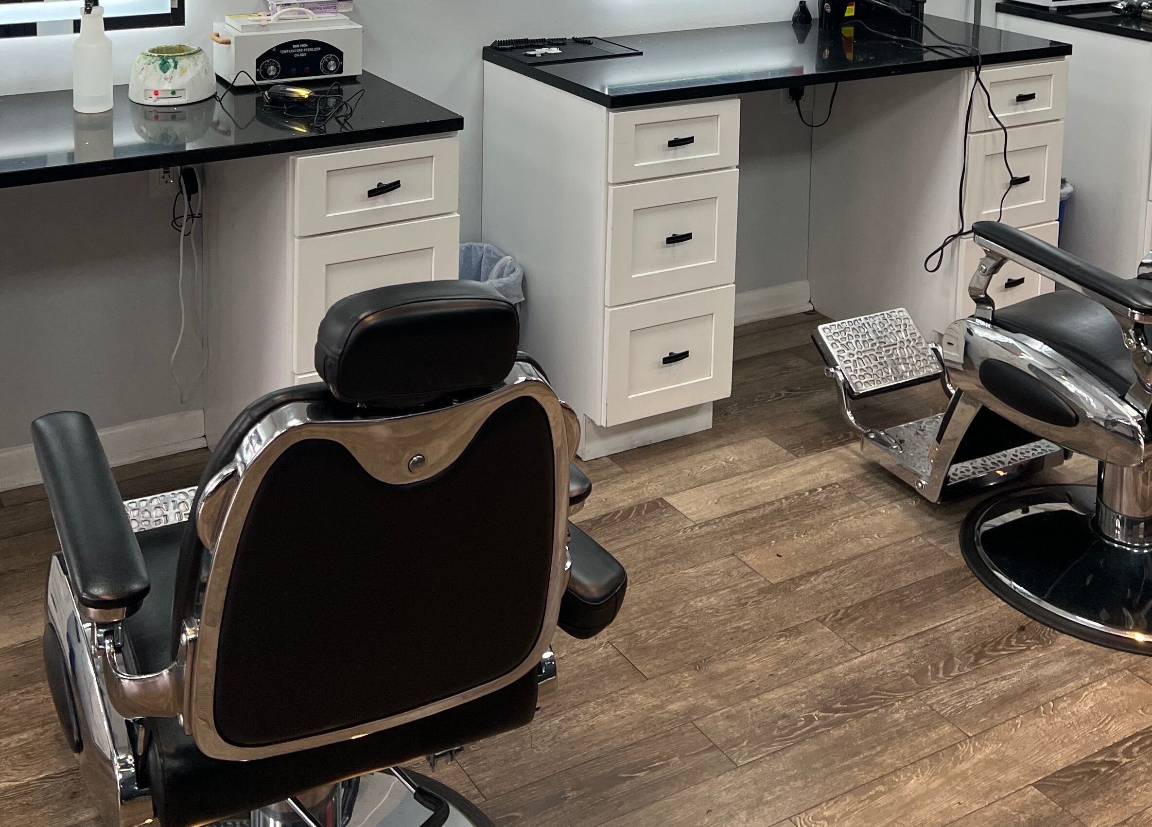 Modern salon setup at King Mostafa's Clips in Falls Church, Virginia, US featuring sleek barber chairs.