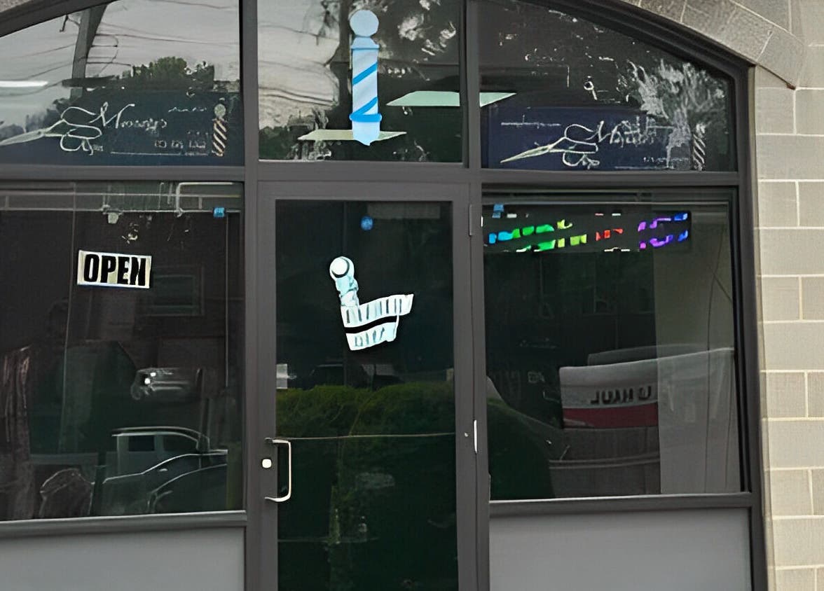 Front entrance of King Mostafa's Clips in Falls Church, Virginia, US featuring a welcoming open sign.