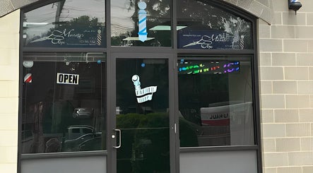 Front entrance of King Mostafa's Clips in Falls Church, Virginia, US featuring a welcoming open sign.