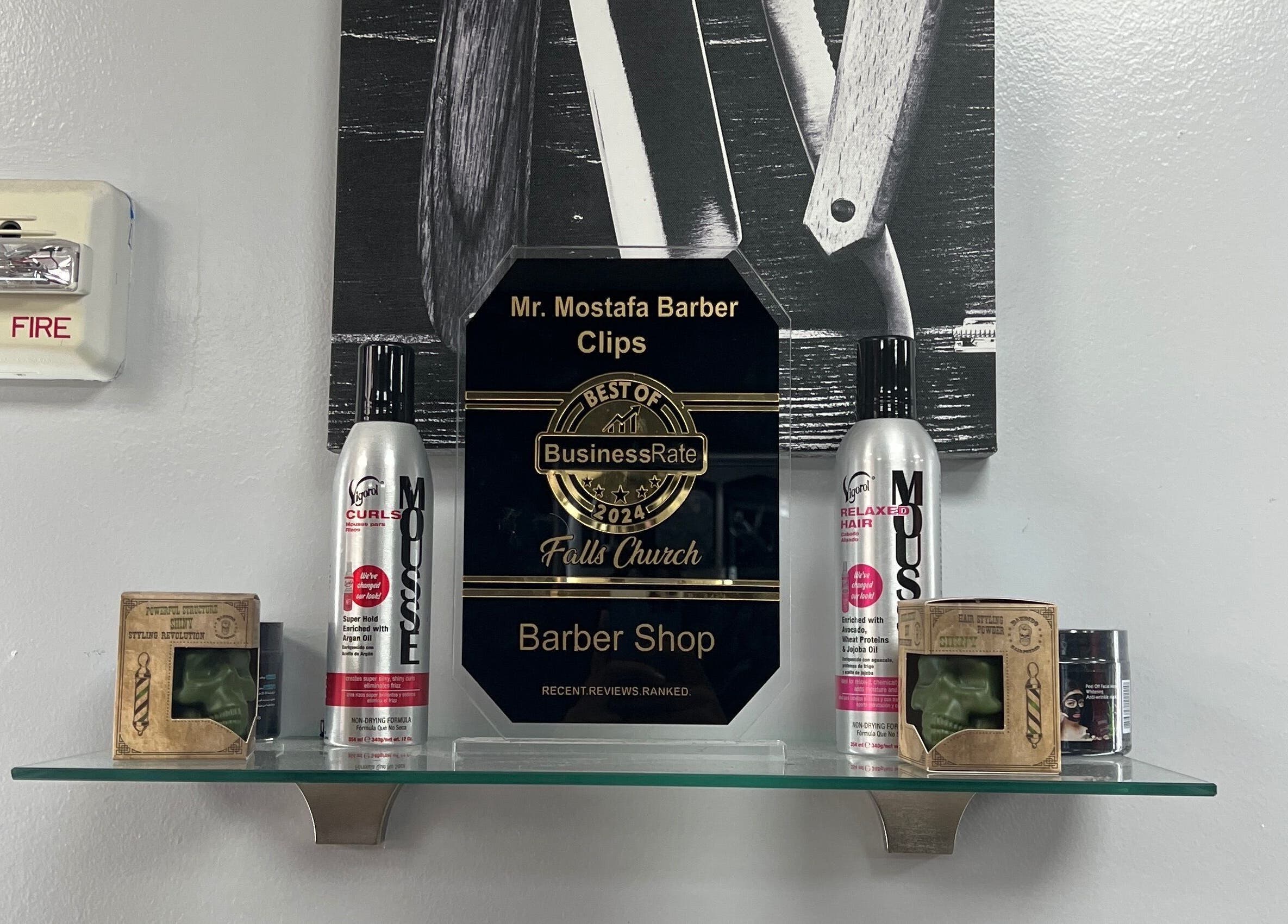 Award display at King Mostafa's Clips, Falls Church, Virginia, US with hair products and a best business plaque.