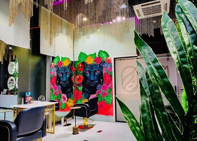Colorful interior of Lovushka Beauty Salon in Doha, Doha Municipality, QA, featuring unique wall art and decor.
