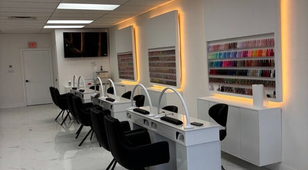 Modern nail salon interior at Sunny Nails Guelph, Guelph, Ontario, CA with stylish workstations and polish display.