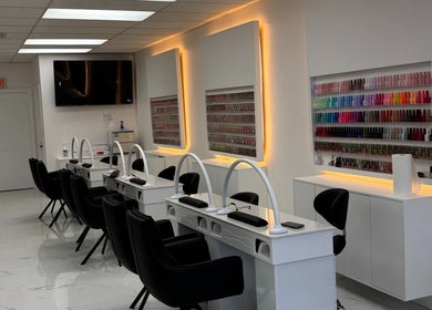 Nail salon interior view at Sunny Nails Guelph, Guelph, Ontario, CA, featuring manicure stations and vibrant polish display.