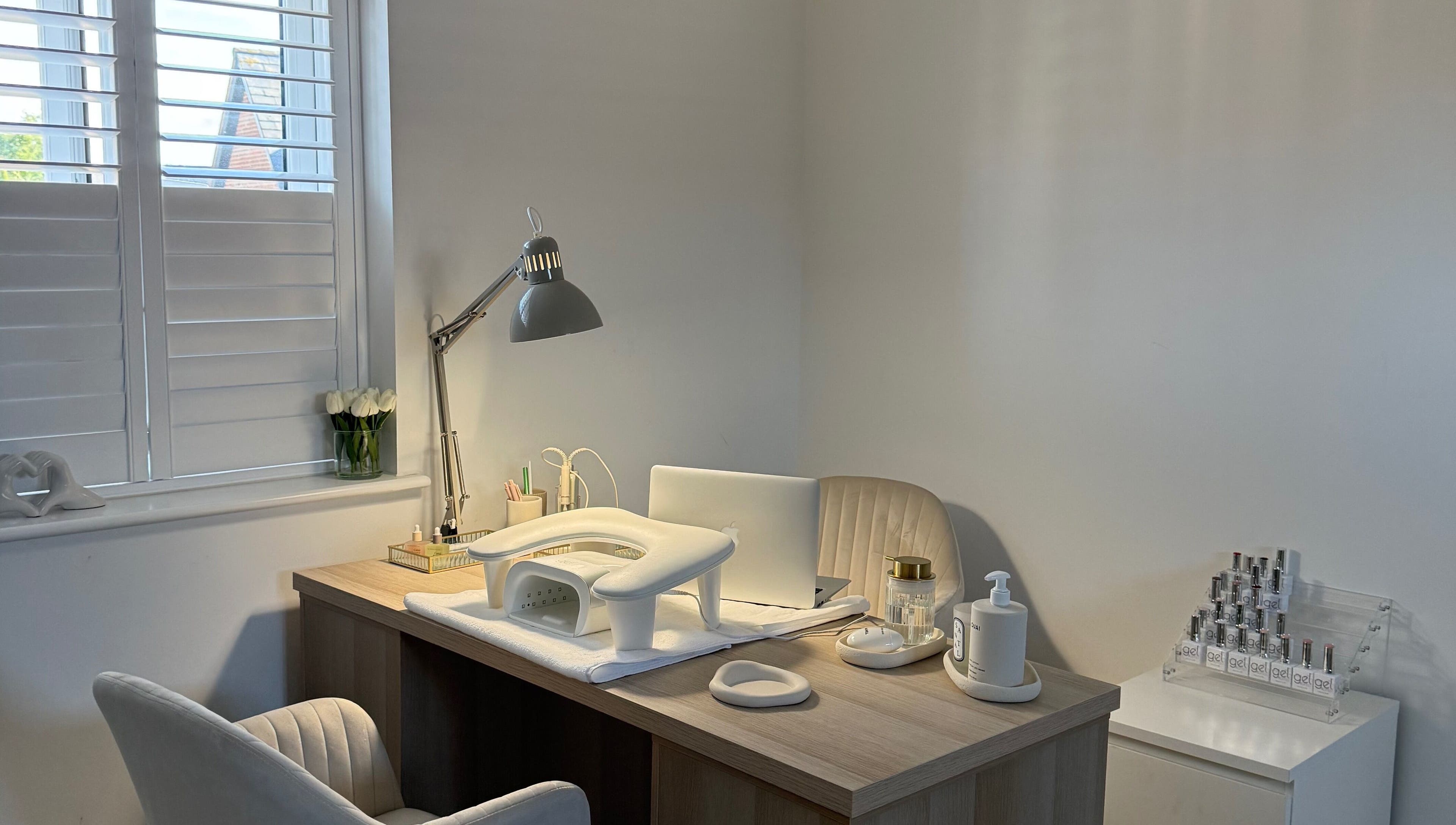 Elegant nail station at BAJE STUDIO, Burgess Hill, England, GB, featuring cozy chair and nail essentials.