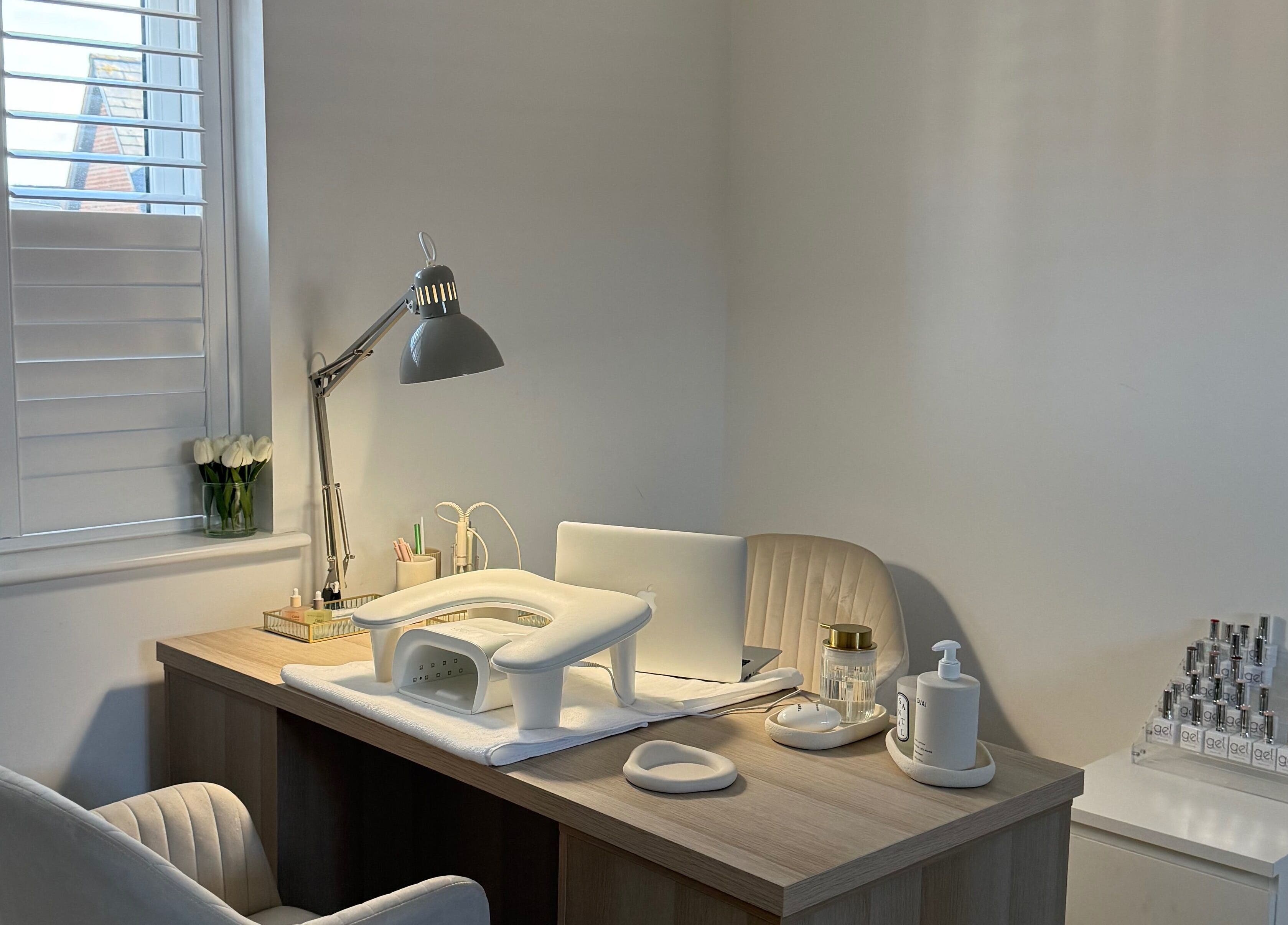 Elegant nail station at BAJE STUDIO, Burgess Hill, England, GB, featuring cozy chair and nail essentials.