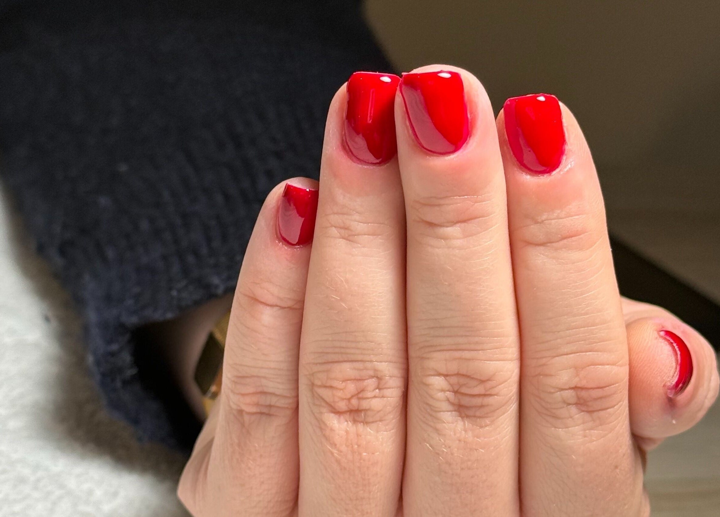 Bright red manicured nails at BAJE STUDIO, Burgess Hill, England, GB, showcasing perfect nail art.
