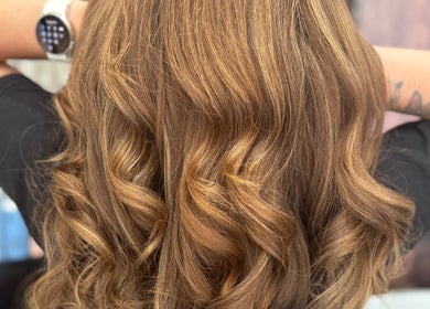 Lustrous golden curls styled at Pins & Curls, Weston-super-mare, England, GB. Perfect for a glamorous look.