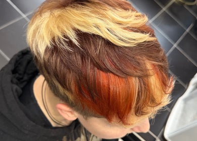 Bold hair coloring with red and blonde hues at Pins & Curls, Weston-super-Mare, England, GB.