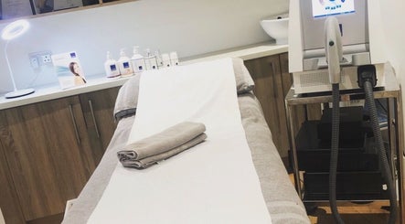 Massage room at Blissful Om Sports Massage, Brighouse, England, GB, with a neatly prepped bed and modern equipment.