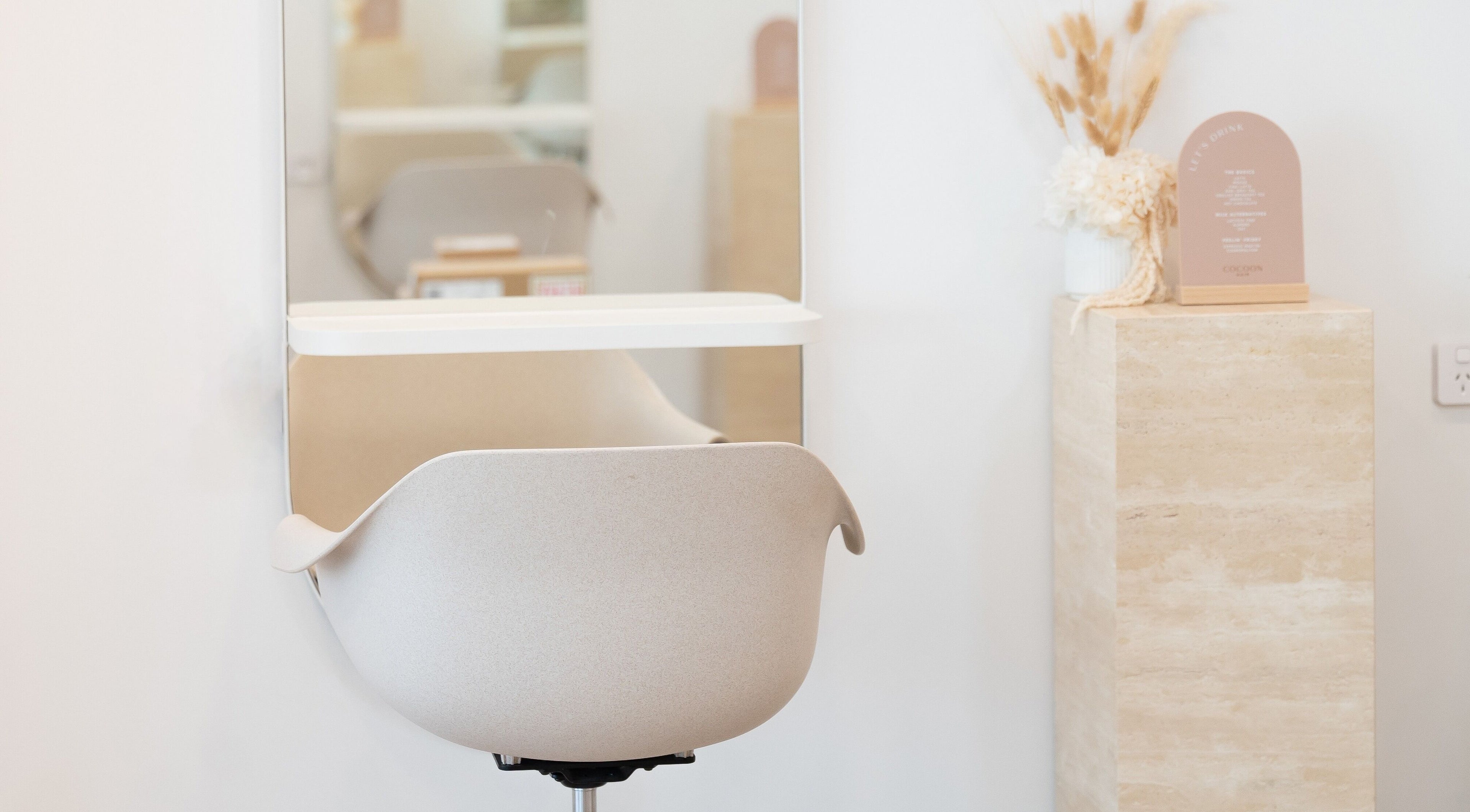 Modern styling chair and decor at Cocoon Hair, Bracken Ridge, Queensland, AU.