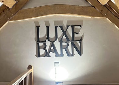 Luxe Barn sign inside Tommo’s Treatments, Tickenham, England, GB showcasing stylish interior design.