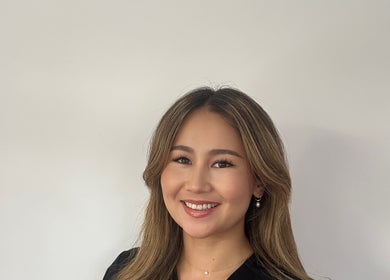 Smiling staff member at Rezai Aesthetics, London, England, GB, offering welcoming service.