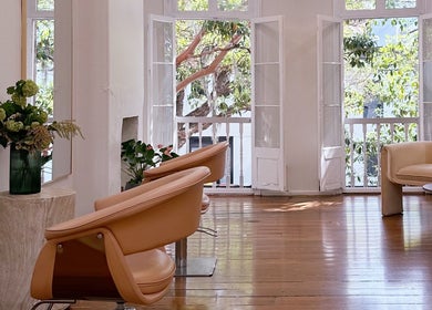 Stylish interior of Stephanie Whitaker Hair salon in Darlinghurst, New South Wales, AU, with lush greenery outside.