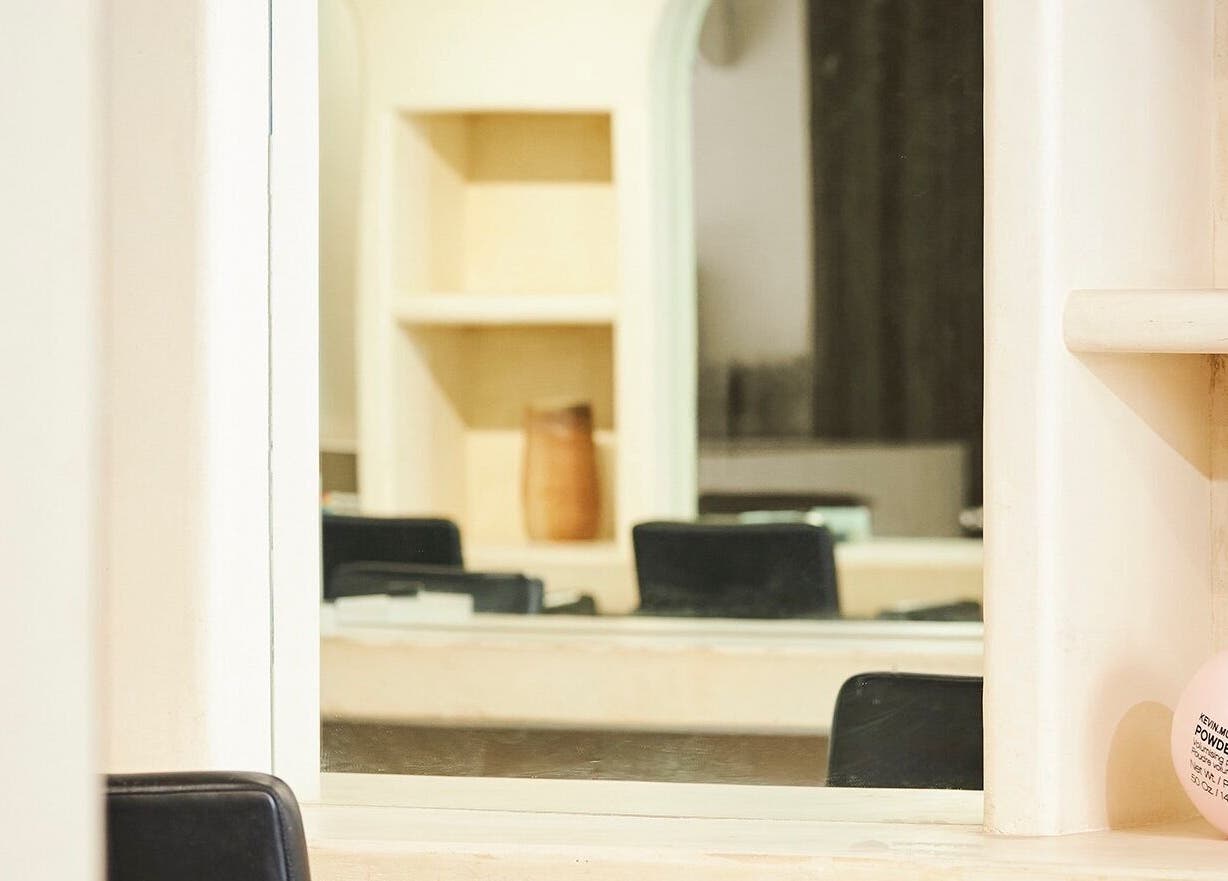 Stylish interior of Fuchs Hair in Alexandria, New South Wales, featuring a modern mirror and chic decor.