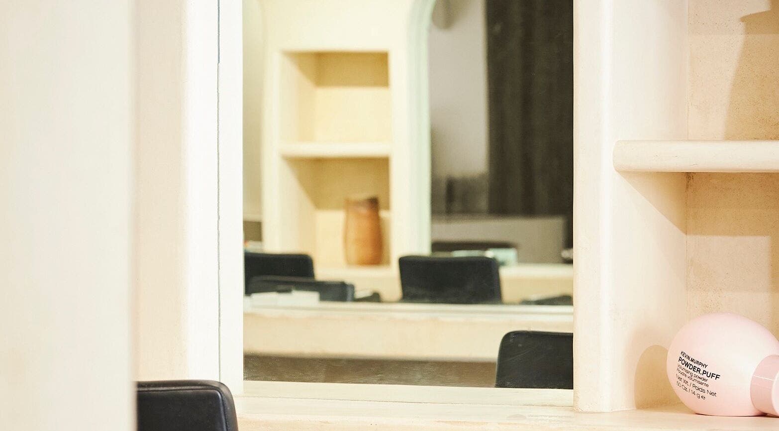 Stylish interior of Fuchs Hair in Alexandria, New South Wales, featuring a modern mirror and chic decor.