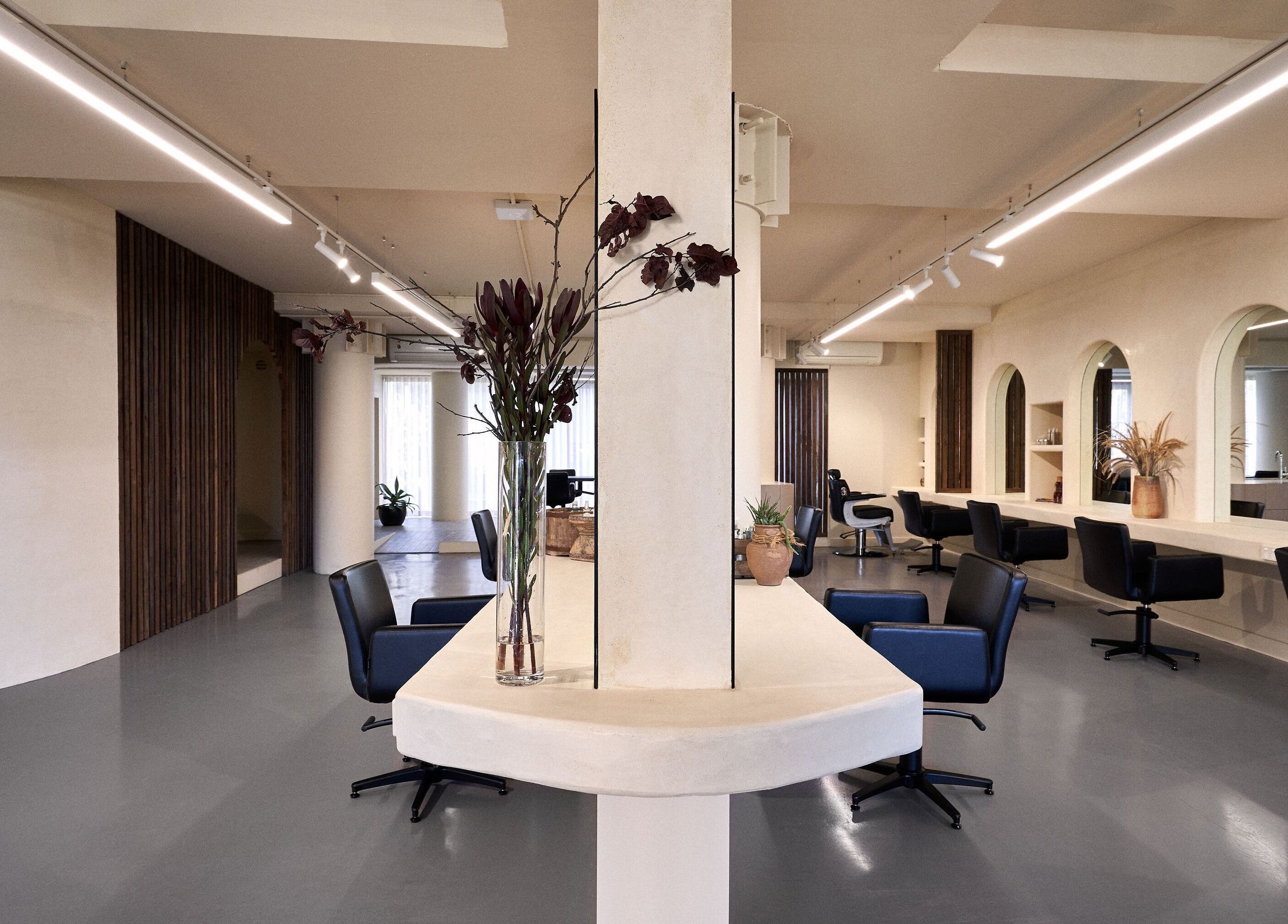 Elegant interior of Fuchs Hair salon in Alexandria, New South Wales, AU with chic chairs and modern decor.