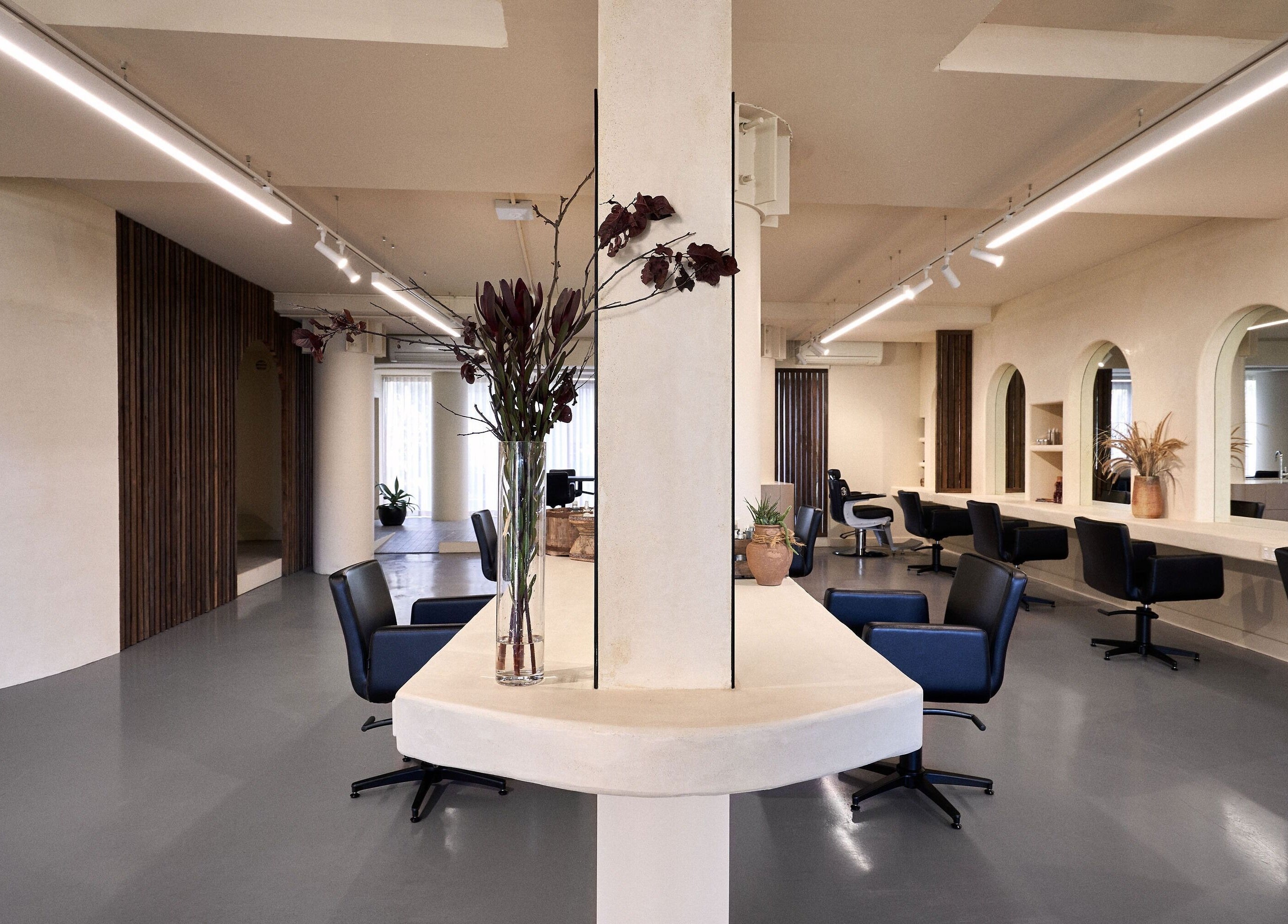 Elegant interior of Fuchs Hair in Alexandria, New South Wales, AU with modern chairs and decor.