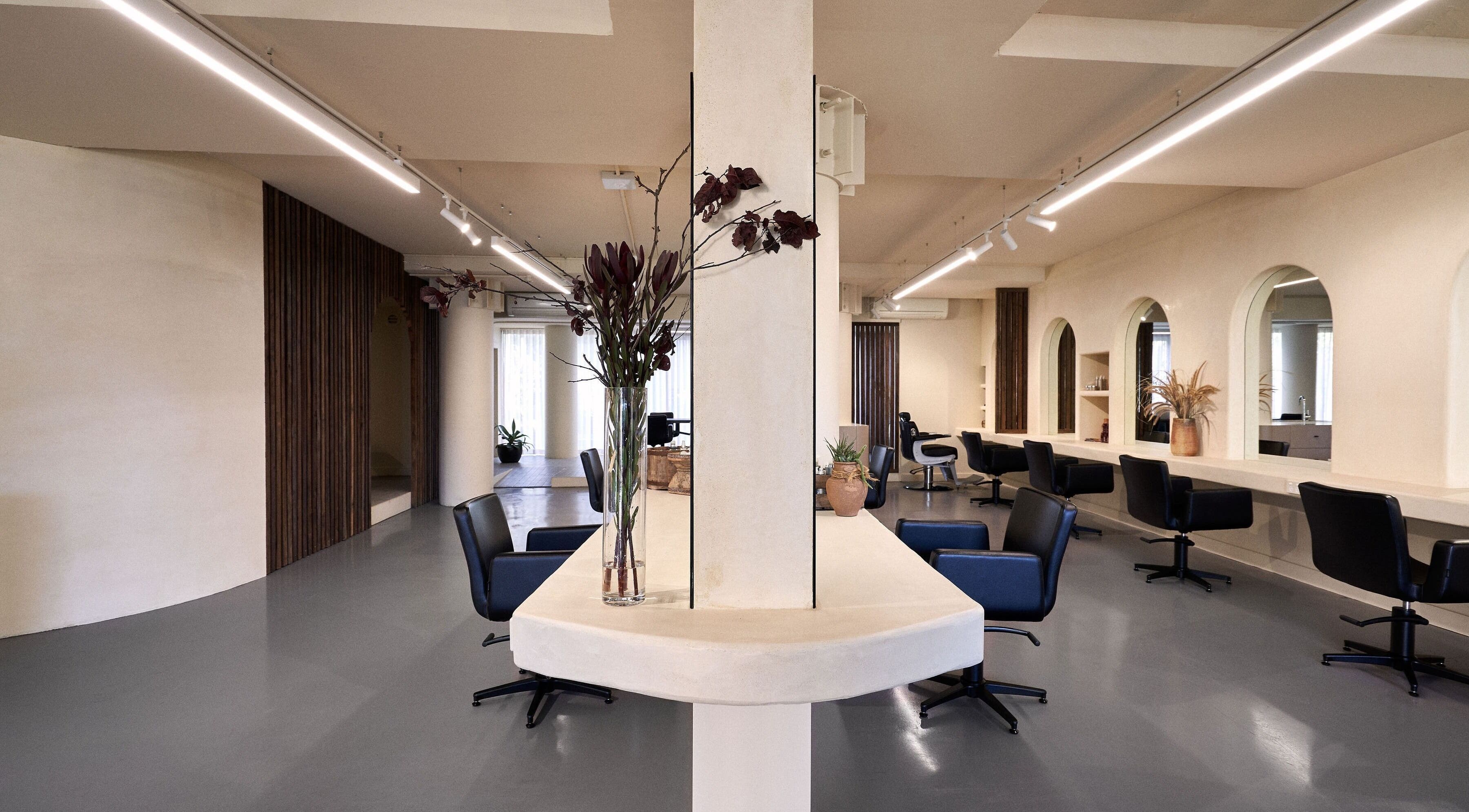 Elegant interior of Fuchs Hair in Alexandria, New South Wales, AU with modern chairs and decor.