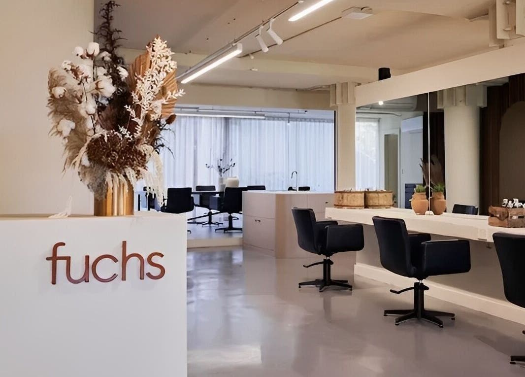 Modern interior of Fuchs Hair in Alexandria, New South Wales, AU featuring sleek styling stations and elegant decor.