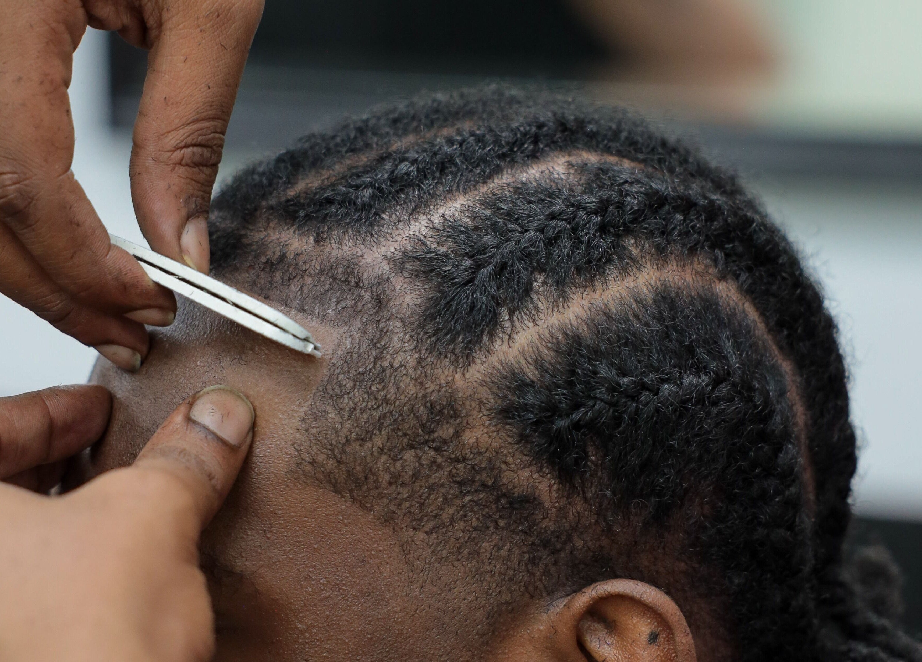 Close-up of hair being styled at Image Unisex Barbershop and Salon in Sicklerville, New Jersey, US.