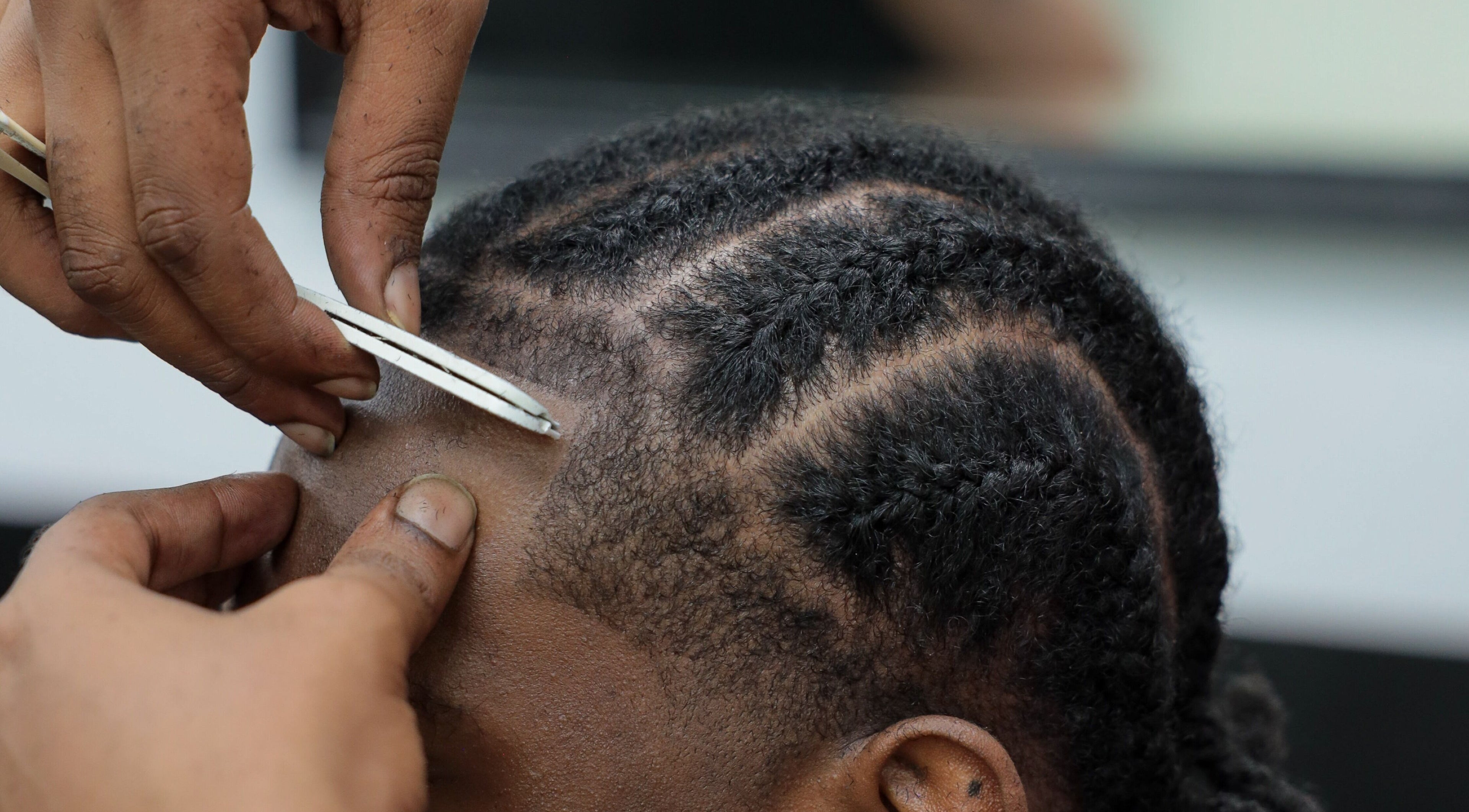 Close-up of hair being styled at Image Unisex Barbershop and Salon in Sicklerville, New Jersey, US.