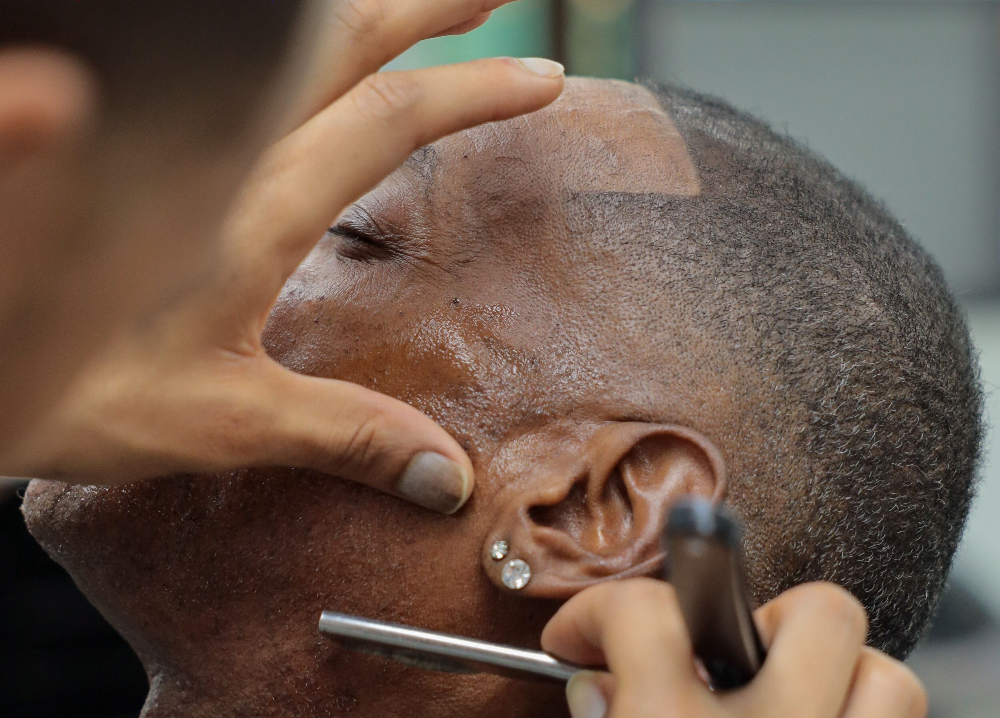 Expert barber shaving client at Image Unisex Barbershop and Salon, Sicklerville, New Jersey, US.