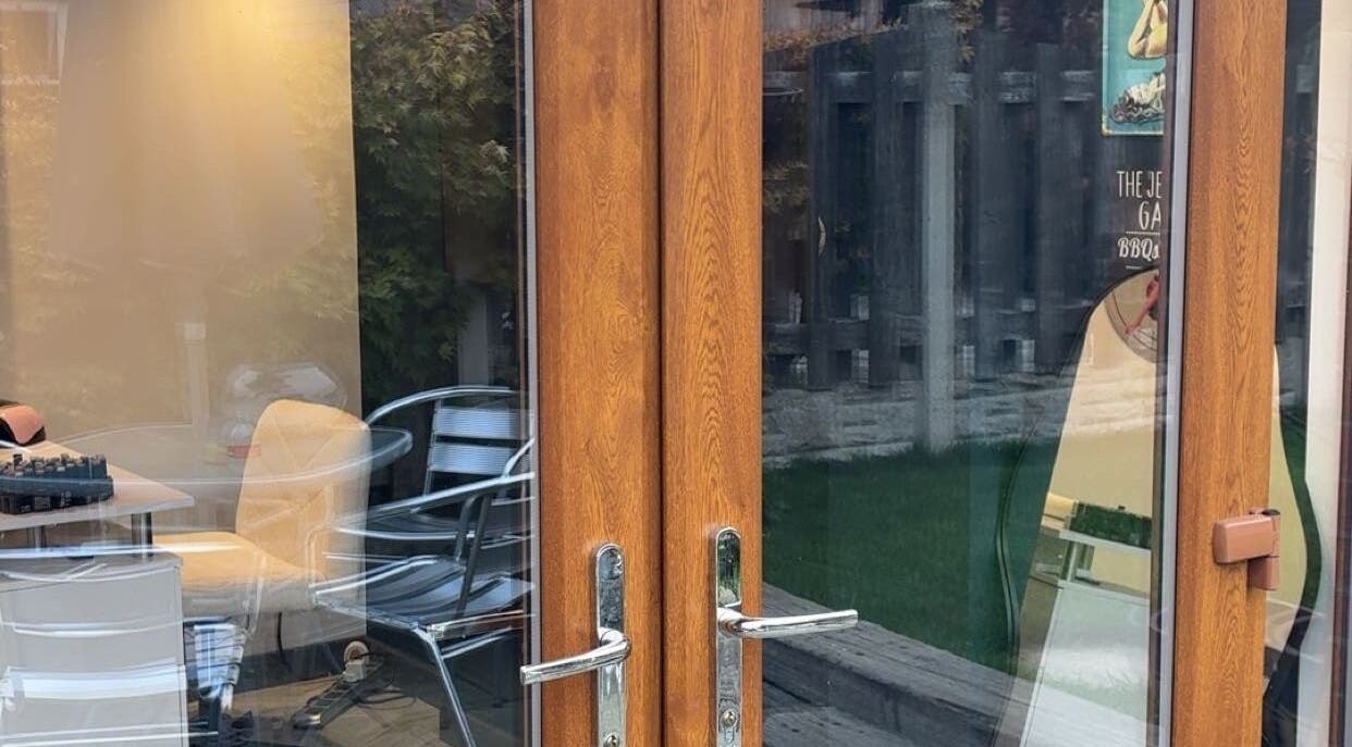 Entrance to Honey’s Haven with wooden doors and garden view in Rotherham, England, GB.