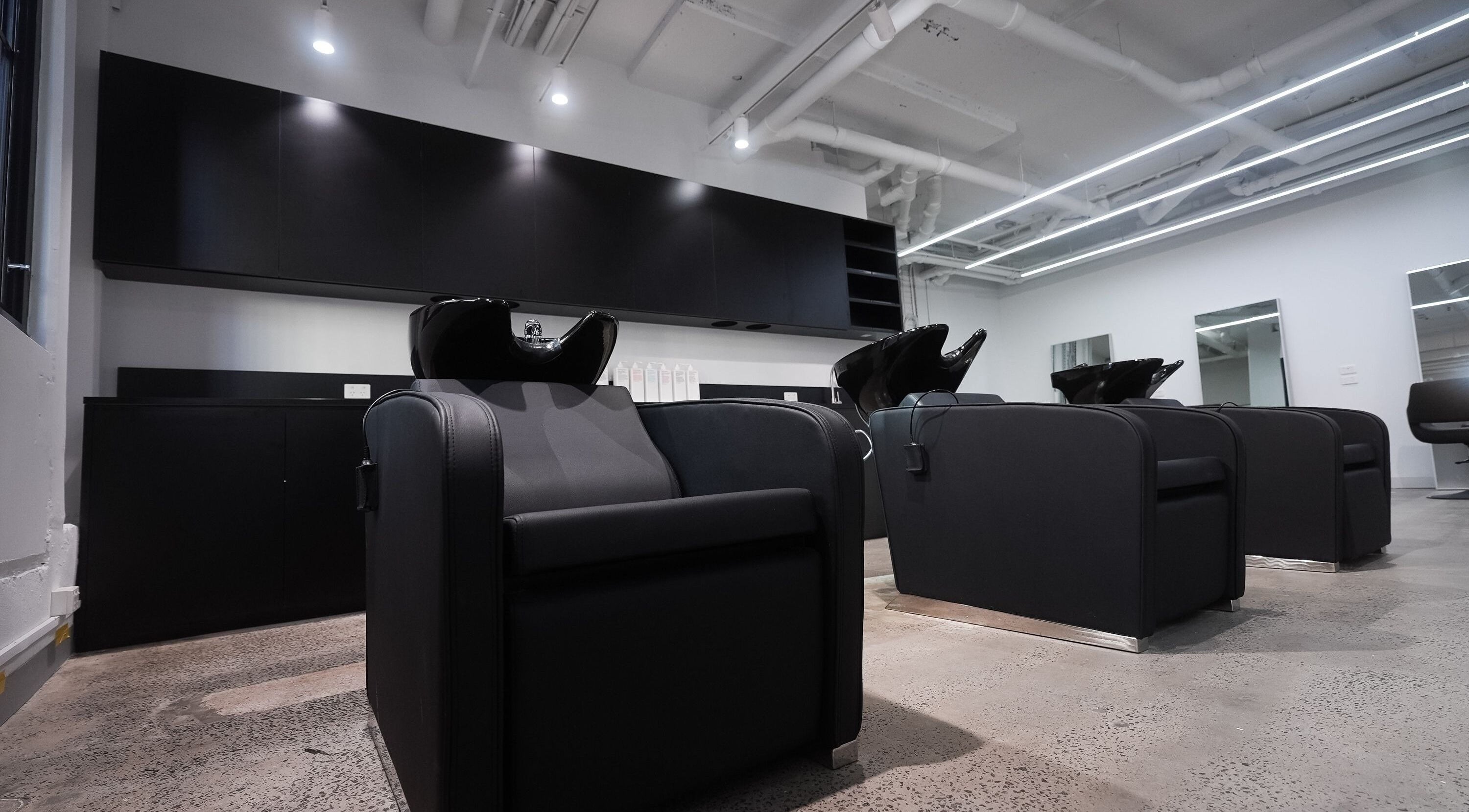 Stylish hair wash stations at ASSORT HAIR PTY LTD in Melbourne, Victoria, AU, offering modern salon services.