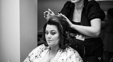 Stylist at KL Creative Hair @ Salon 22, Enniskillen, creating elegant hairstyle for a client.