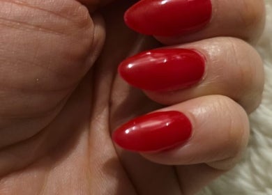 Vibrant red manicured nails from NailsByKrista, Newmarket, England, GB, showcasing expert nail artistry.