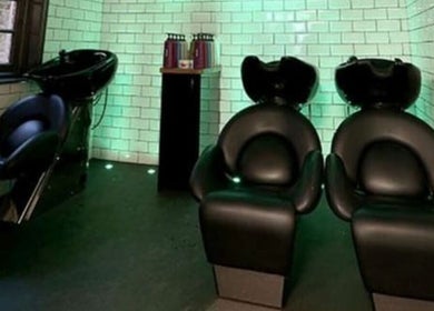 Modern wash stations at Keir at Aldwick Hair in Bognor Regis, England, GB, featuring sleek black chairs.