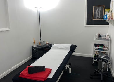 Therapy room at Physio Edge Films, London, England, GB, featuring a treatment table and wellness supplies.