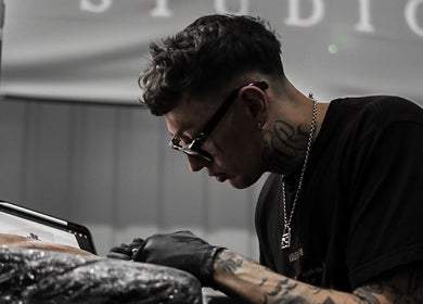 Jay Soze Fineline Tattoo Artist in action at Peterborough, England, GB, crafting detailed ink designs.