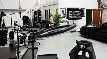 Modern interior of Jay Soze Fineline Tattoo Artist studio in Peterborough, England, GB with sleek black decor.