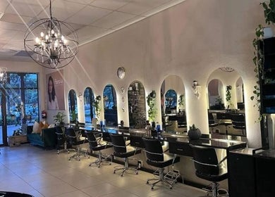 Elegant salon interior at Tella The Hybrid Stylist, Pretoria, Gauteng, ZA with stylish mirrors and chic lighting.