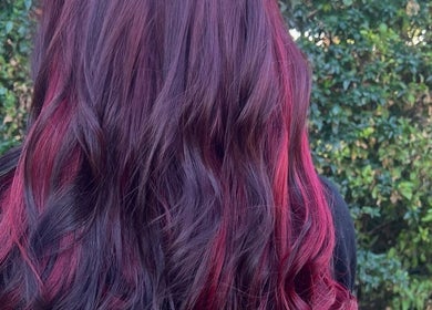 Vibrant red hair styled in waves by Tella The Hybrid Stylist in Pretoria, Gauteng, ZA.