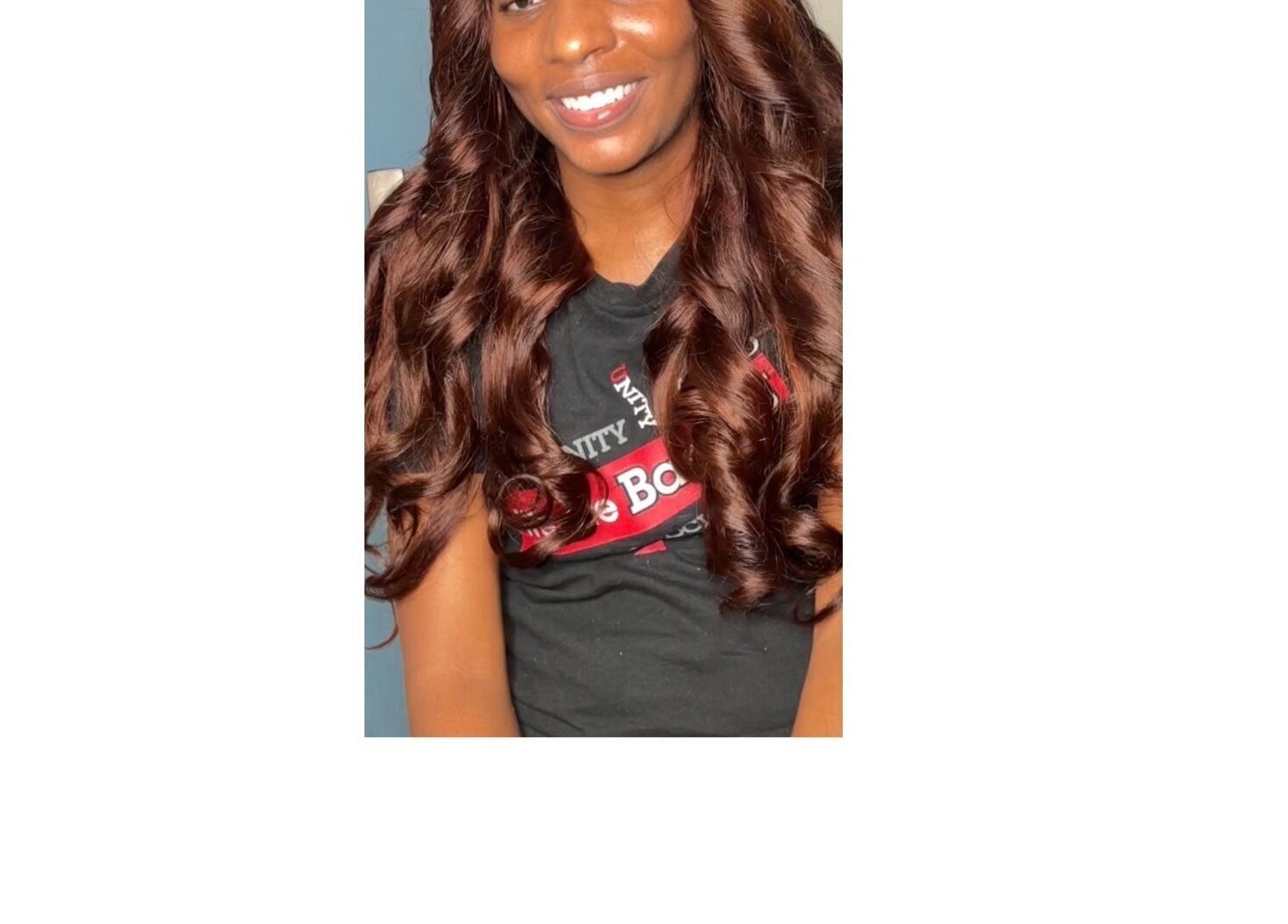 Smiling woman with curled hair at Crownedbycassie in Lauderhill, Florida, US.