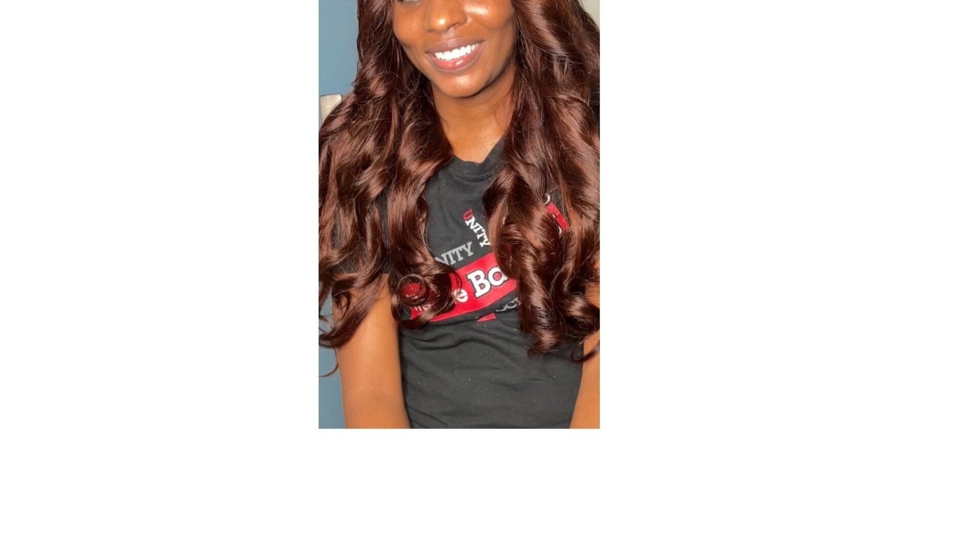 Smiling woman with curled hair at Crownedbycassie in Lauderhill, Florida, US.