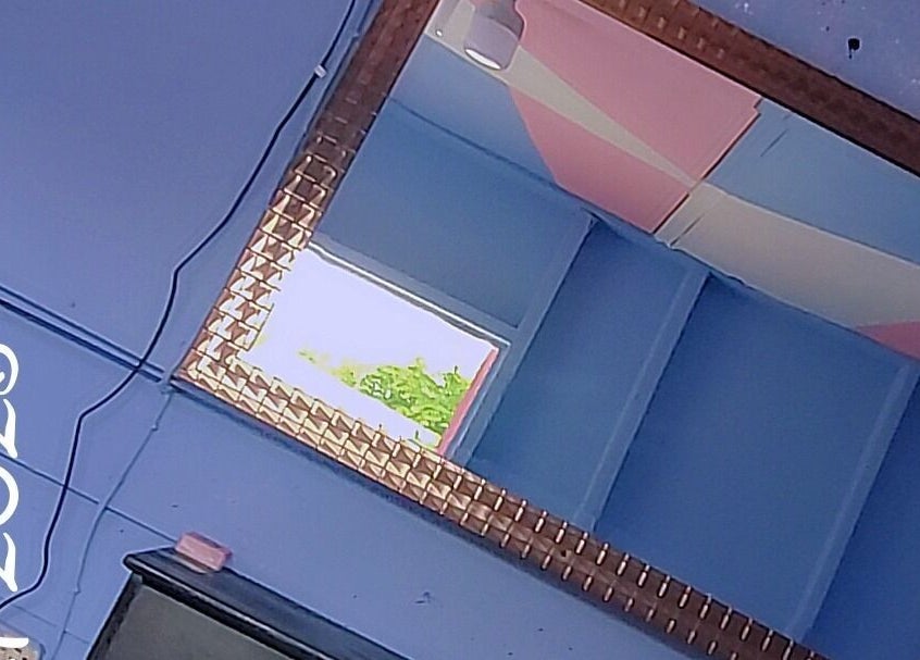 Stylish mirror at Beauty by Nicole, Grange Hill, Westmoreland Parish, JM, reflecting a bright, serene room.