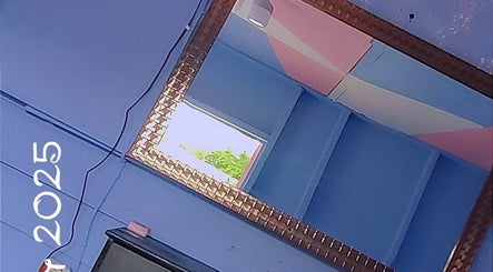 Stylish mirror at Beauty by Nicole, Grange Hill, Westmoreland Parish, JM, reflecting a bright, serene room.