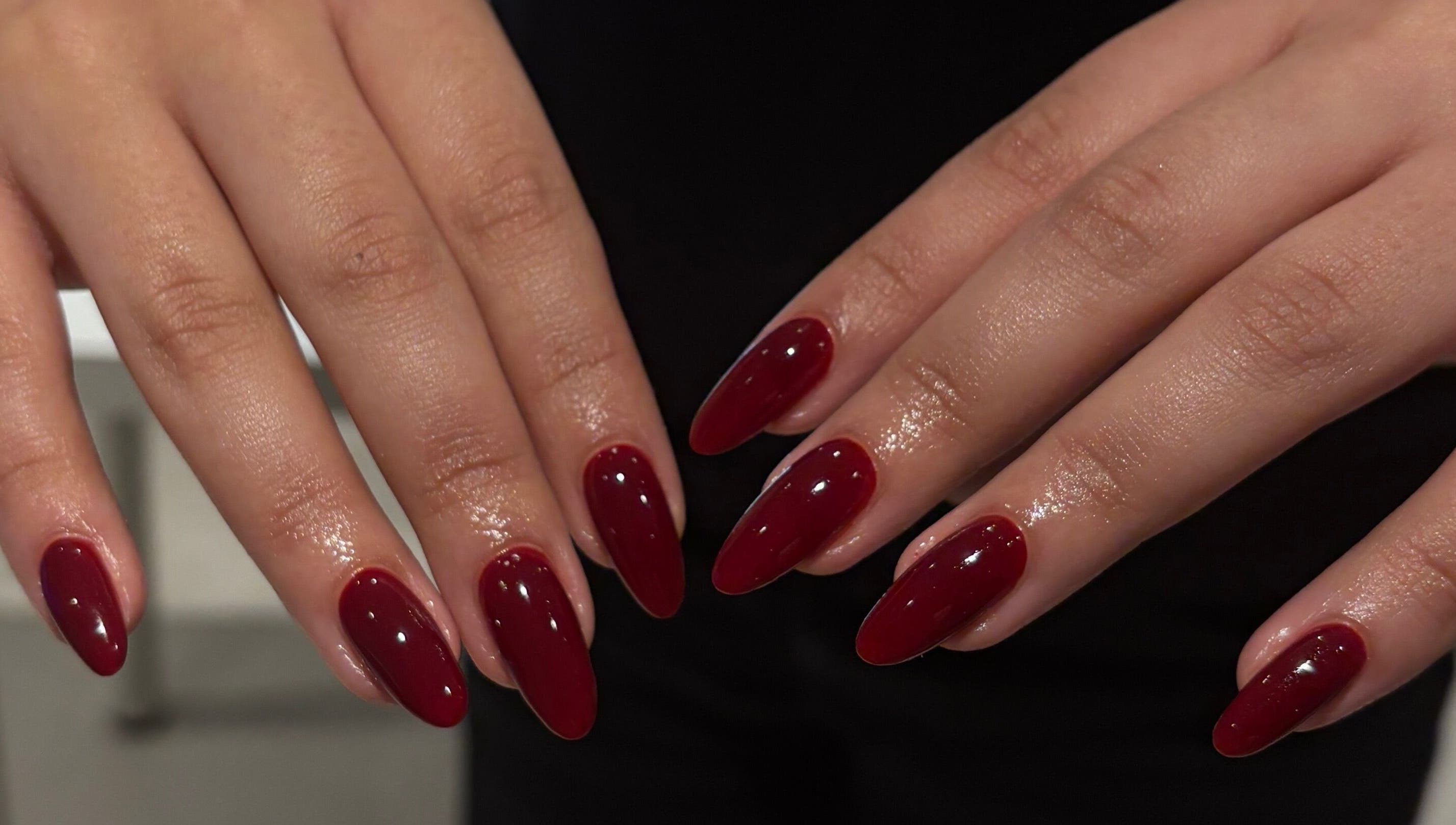 Elegant maroon manicure at Katiedonails in Vancouver, British Columbia, CA, showcasing exquisite nail artistry.