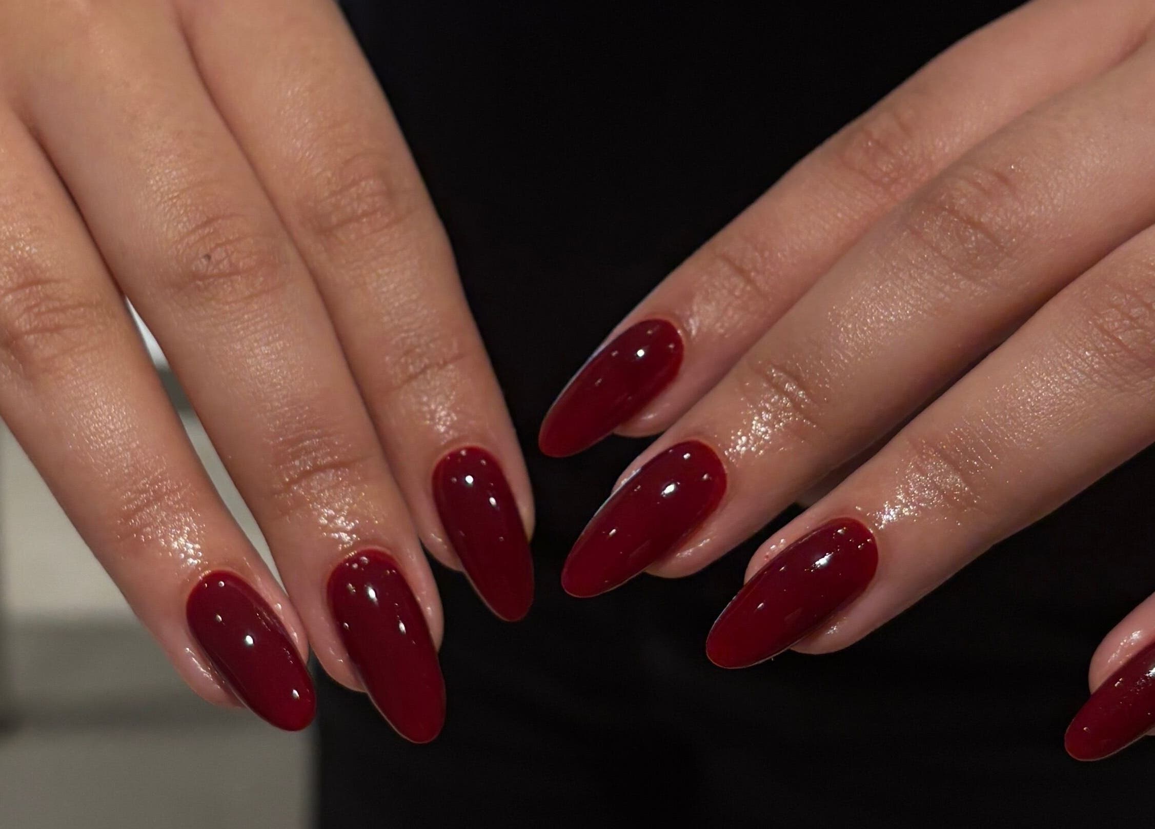 Elegant maroon manicure at Katiedonails in Vancouver, British Columbia, CA, showcasing exquisite nail artistry.